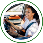 A woman wears her seatbelt as she drives her car. 